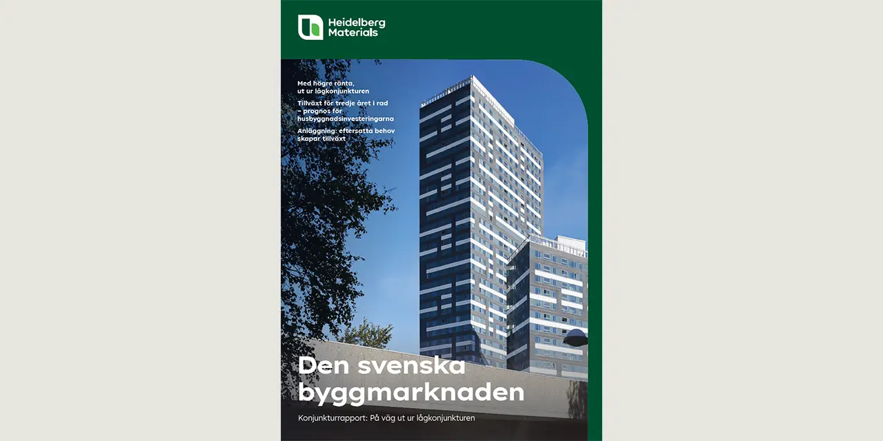 Höghus med moderna fasader under en klar himmel, omgiven av träd.